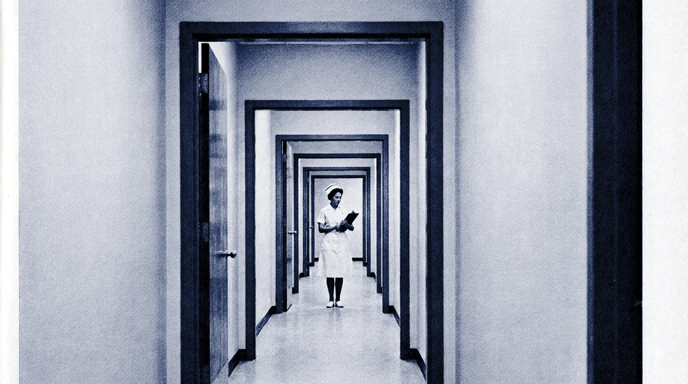 Nurse with clipboard in clinic corridor